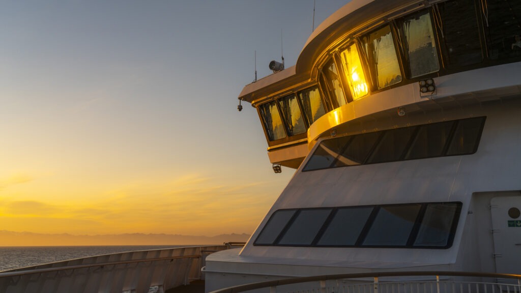 Aufnahme des Oberdecks der MS Fridtjof Nansen im warmen Licht eines Sonnenuntergangs vor der Küste von Bakkagerði, Island.