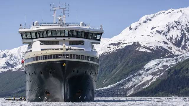 Expeditionsschiff MS Roald Amundsen vor verschneiten Bergen in Alaska